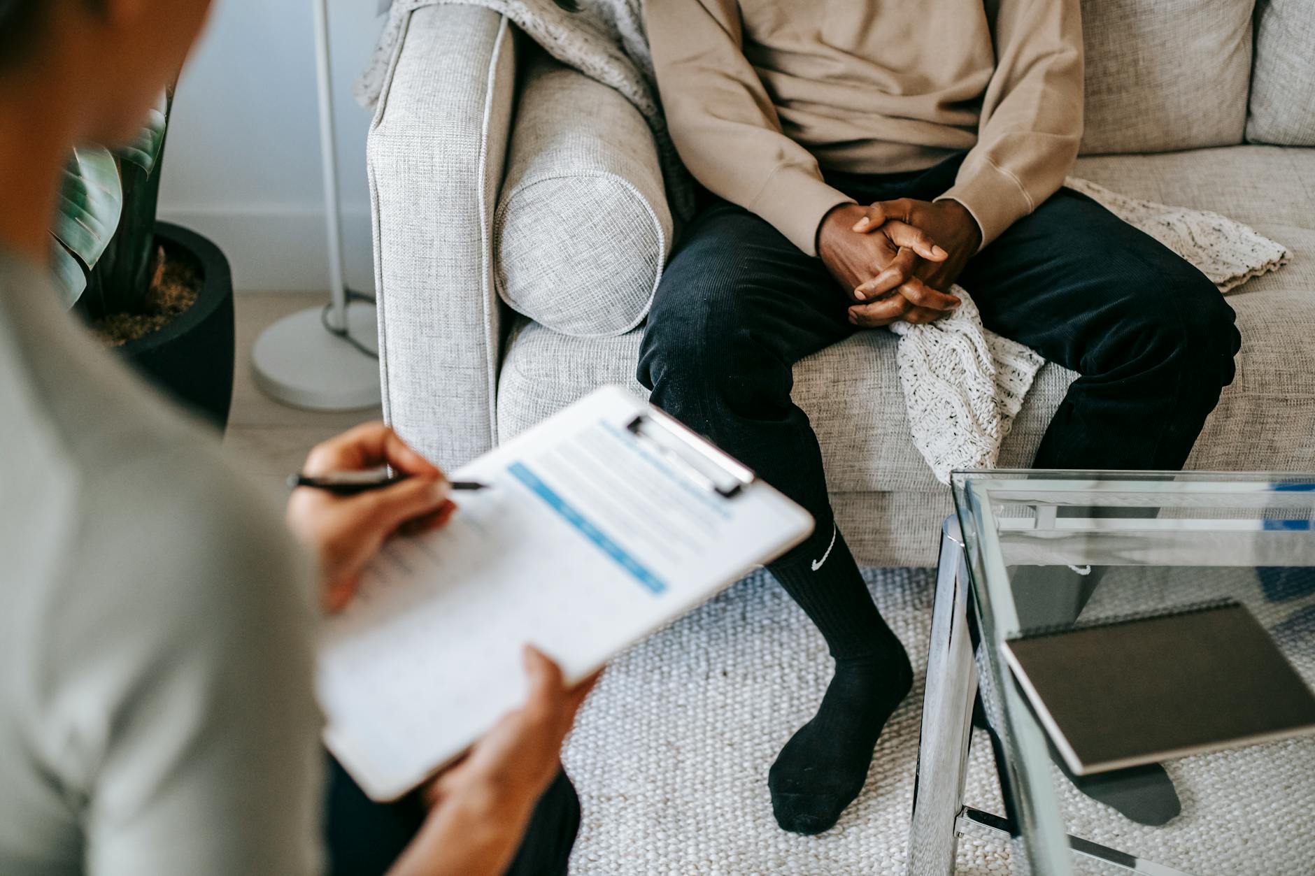 crop ethnic client discussing problems with anonymous psychologist